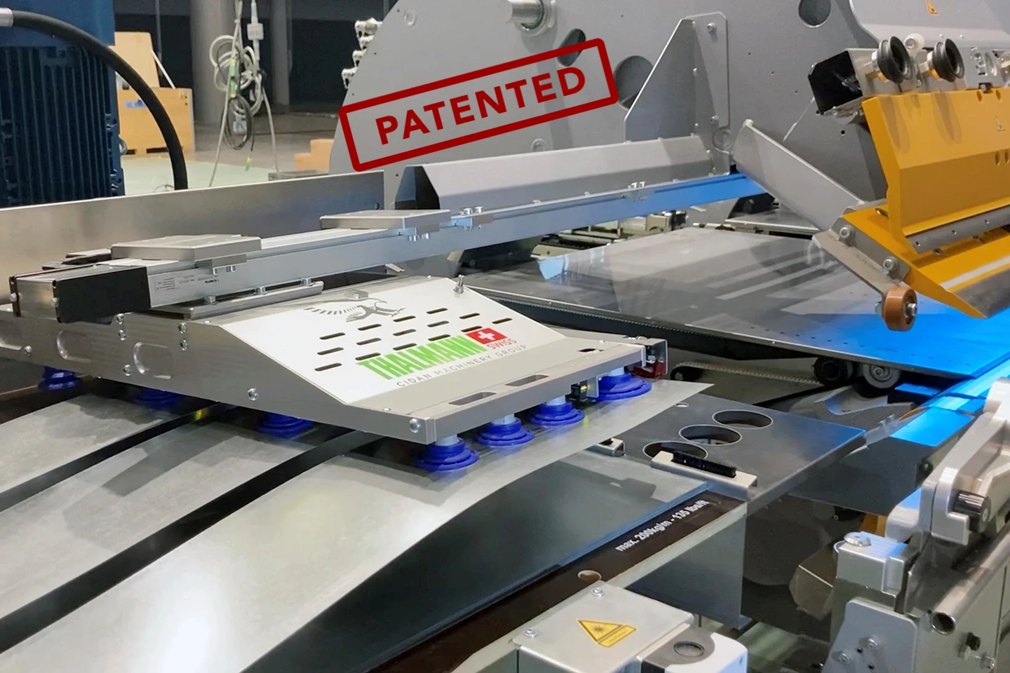 multi head side loader loading a thalmann td double folder with metal sheets